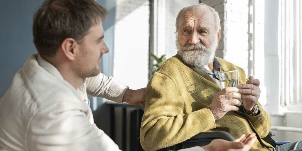 Un homme prend soin d'un senior qui bénéficie de la PCH